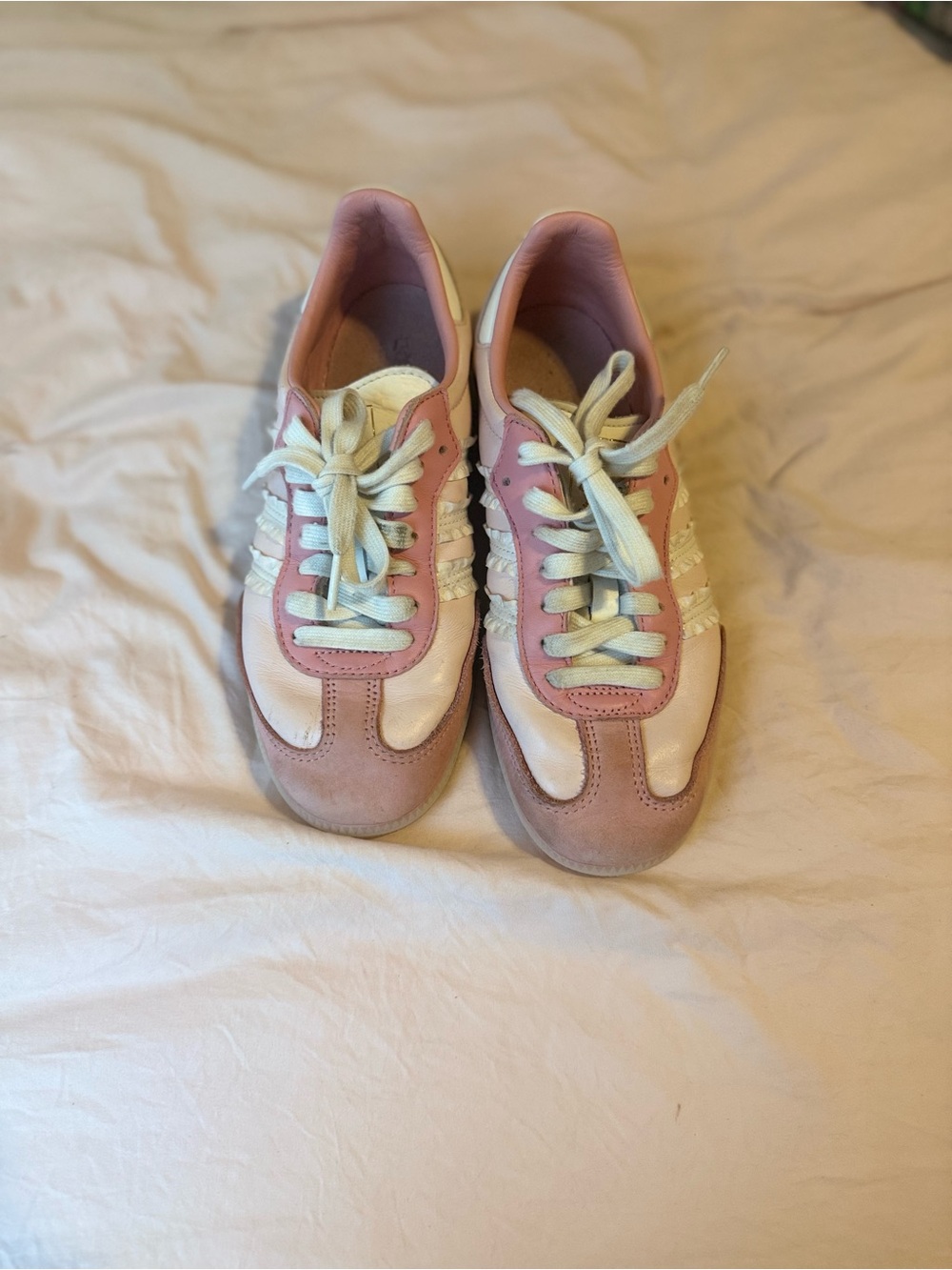 Pink and white adidas sambas with ruffles on the side